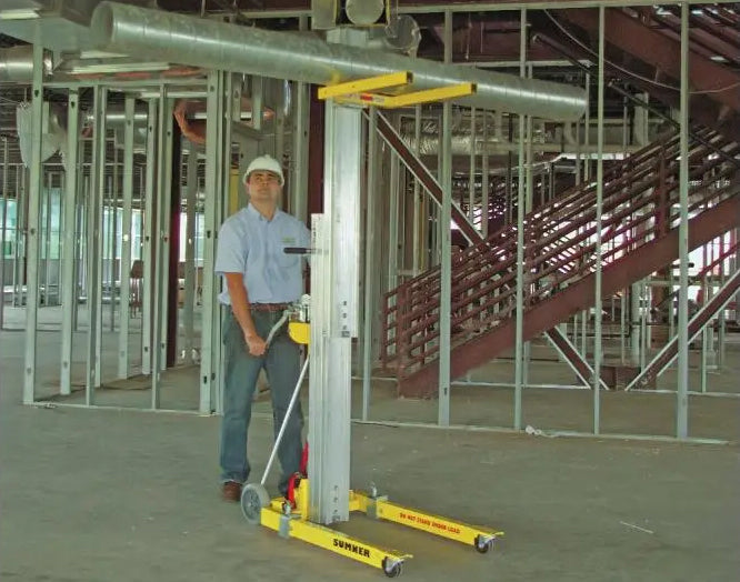 A man in a hard hat using a Sumner HVAC Duct Lift